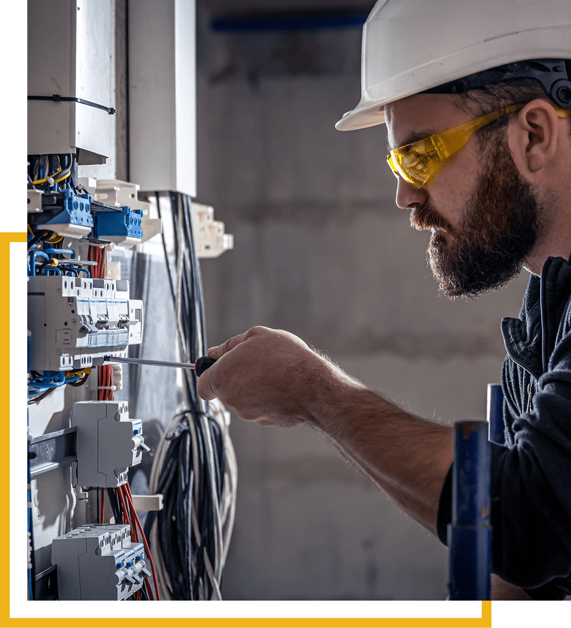 Electrician working on electrical panel wiring.