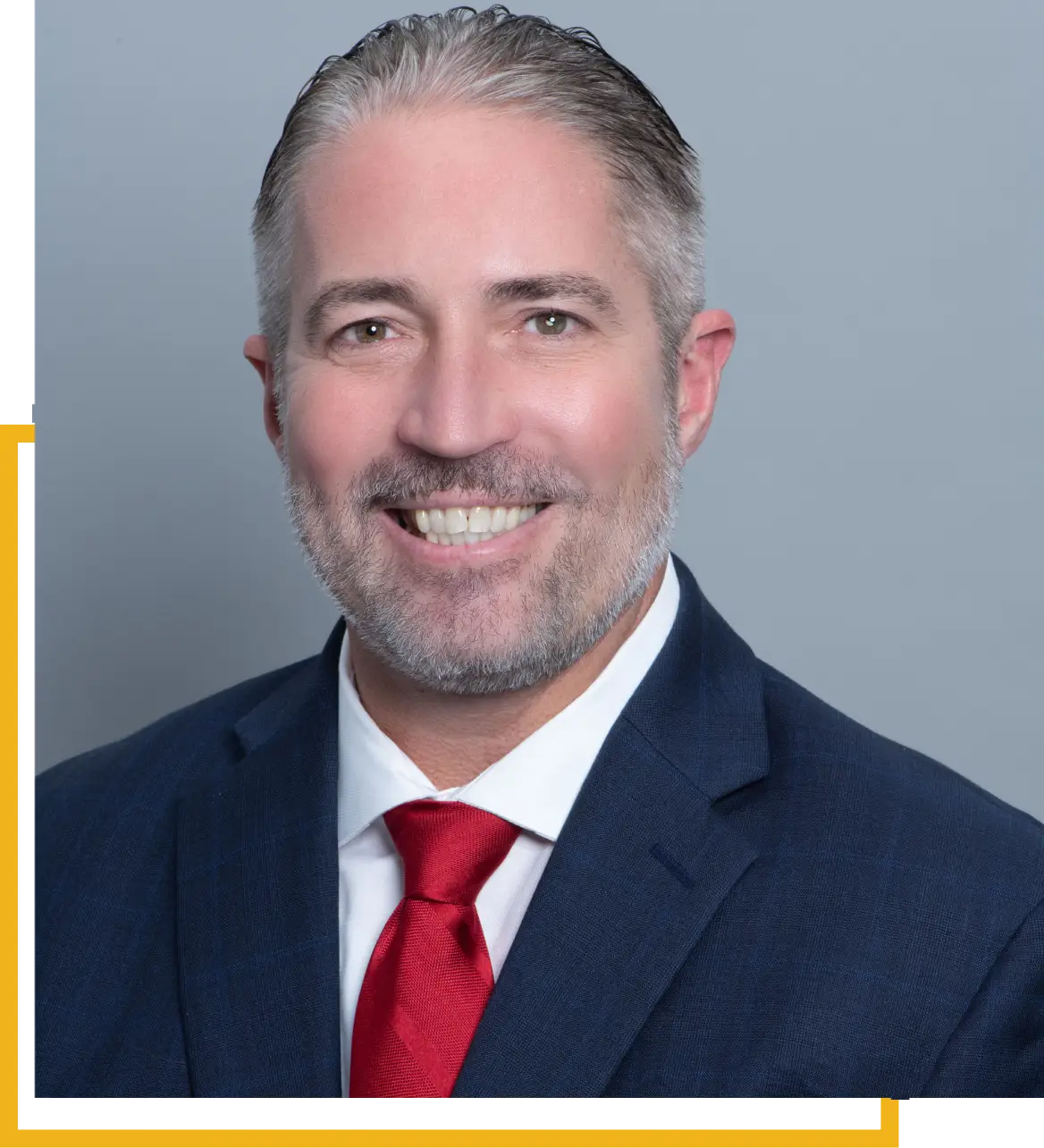 Professional man in suit with red tie smiling.
